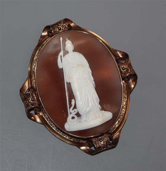 A Victorian yellow metal mounted oval cameo shell pendant brooch, carved with the figure of Pallas Athena and the serpent, 73mm.